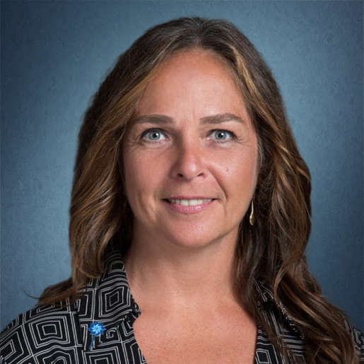 Headshot of Anita with dark blue background