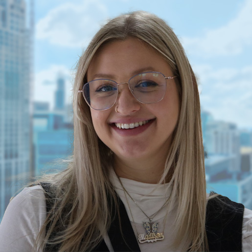 Headshot photo of Maddie Czworka, Development Manager at Prevent Child Abuse America with a city background